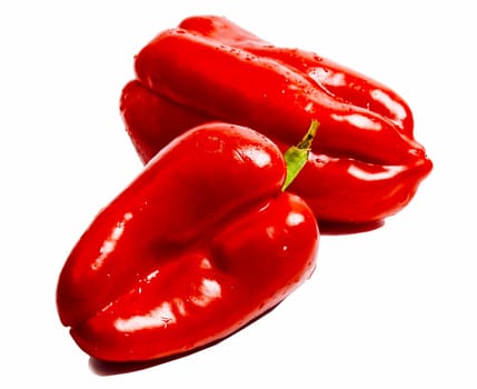 Two red bulgarian peppers isolated on white