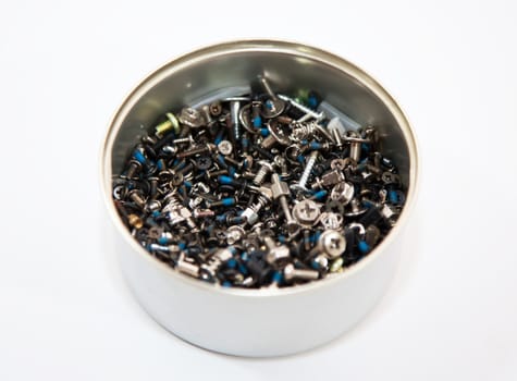 Jar of hobnails and screws on the white background