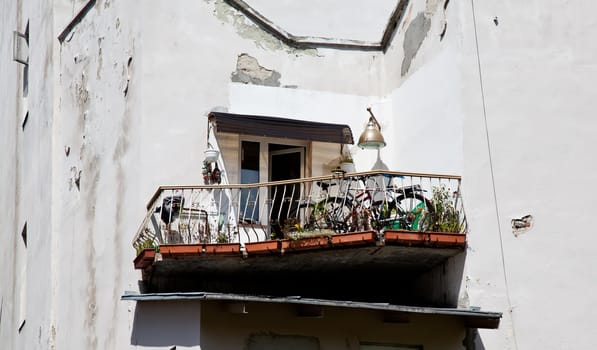 Unusual form balcony with flowers and bicycles