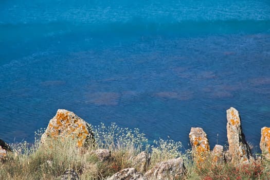 Black sea clear water through stones