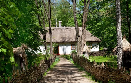 Road to rustic cottage with fence