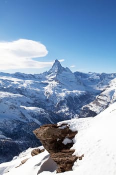 Winter swiss landscape with Matterhorm mountain and stone