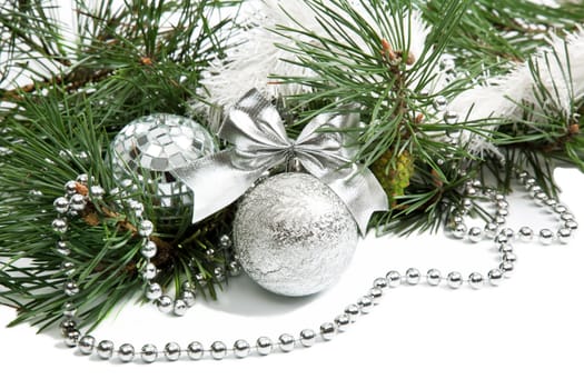 Christmas firtree branch with silver balls, beads and ribbon