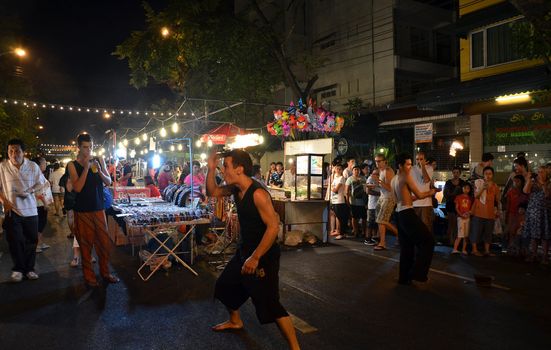 BANGKOK - DEC 16: Crowd walk through the Phra Athit Walking Street, "Rattanakosin recall" festival on December 16, 2012 in Bangkok, Thailand. Its a tourist attraction primarily for night life and entertainment