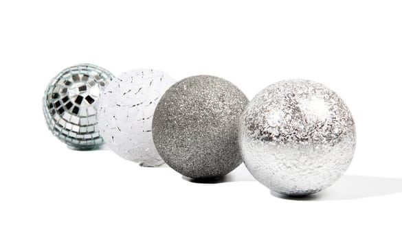 Four Christmas silver balls on white background