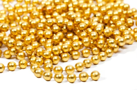 Golden beads garland on white background