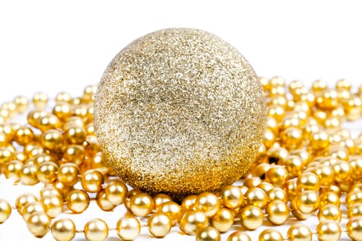 Golden Christmas decoration ball among golden beads