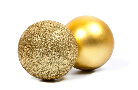 Two Christmas golden balls on white background