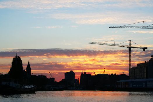 Industrial sunset on the river with crane