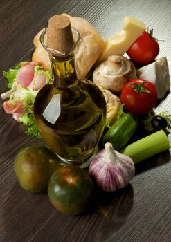 Provence Snacks and Appetizers with Vegetables, Ham, Ciabatta, Cheese and Olive Oil closeup on Dark Wood background