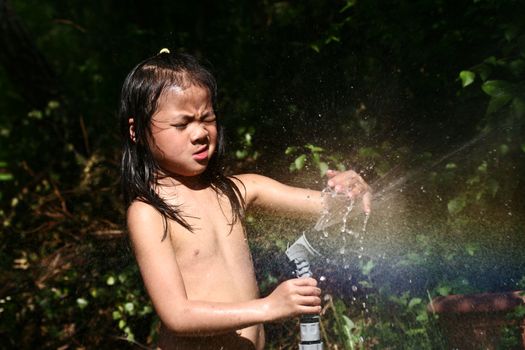 close up of child head splashing with water