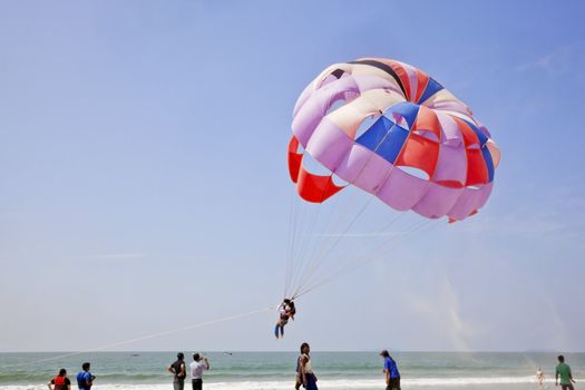 Landscape of paraglider taking off leaving a trail of sand blowing in the breeze