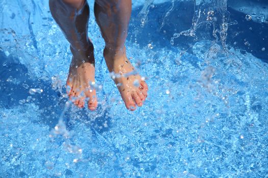 child  having fun with water  a summer day in a pool