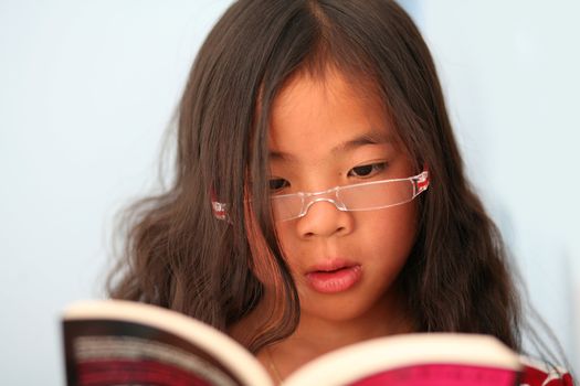 child reading a book ans studying  (chinese child)
