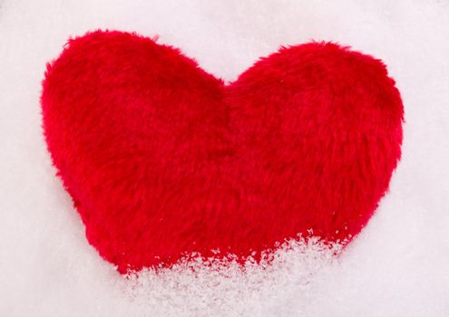 Red heart in snow
