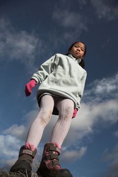 happy child outdoor jumping a summer day
against a blue sky
