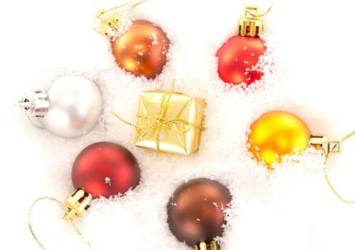 Christmas tree balls and gift in snow