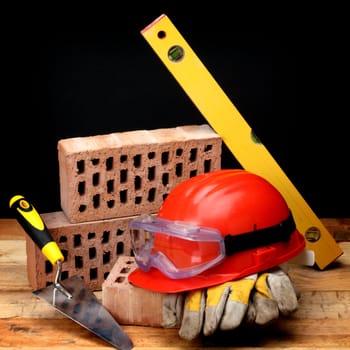 Bricks, trowel and helmet on work place 