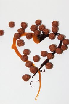 heart of caramel and chocolate on a white background as a symbol of love