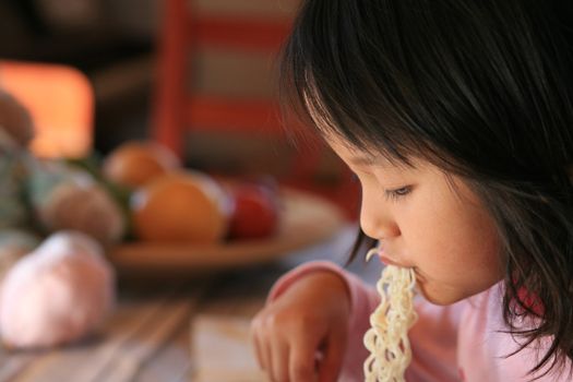  close up of hungry child eating pasta
