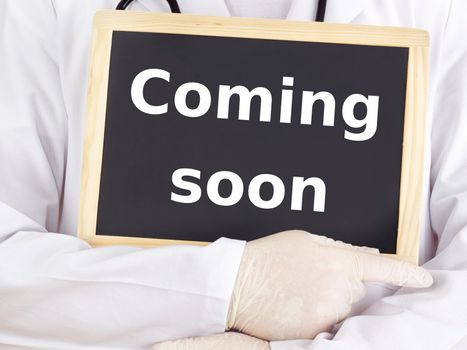Doctor shows information on blackboard: coming soon