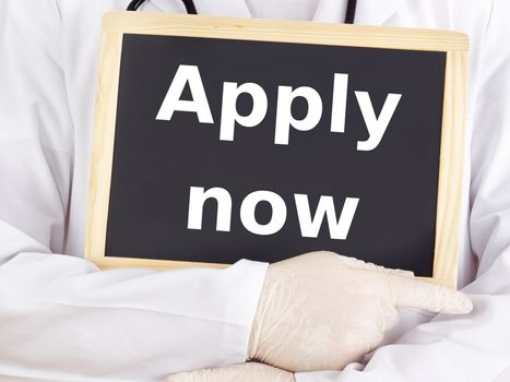 Doctor shows information on blackboard: apply now
