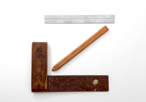 Carpenter's Framing Square, Pencil and Ruler on White Backdrop