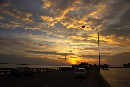 CHONBURI, THAILAND-AUGUST 28 : Car park on bridge for see nice sunset sky on August 28,2012 in Kho Loy islands, Chonburi, Thailand