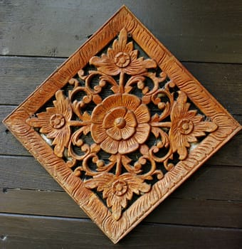 Flower carving art on wooden wall, Retro art in Thailand