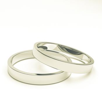 A pair of isolated silver or platinum weddings rings.