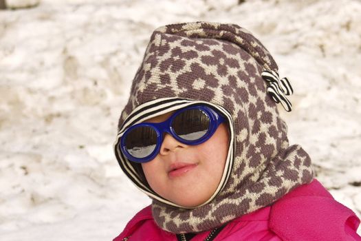 child playing  the snow a sunny winter  day