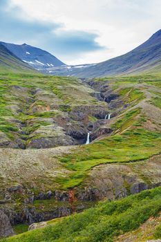 Waterfall in Iceland, landscape with beautiful nature. Vertical view