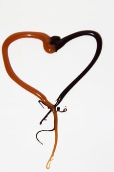 heart of caramel and chocolate on a white background as a symbol of love