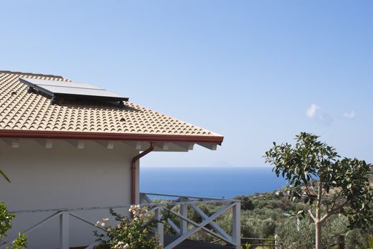 house by the sea with panels solar on the roof