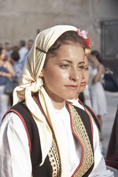 POLIZZI GENEROSA, SICILY - AUGUST 19: Beautiful Women of Bosnia folk group and sicilian men at the International "Festival of hazelnuts": August 19, 2012 in Polizzi Generosa,Sicily, Italy