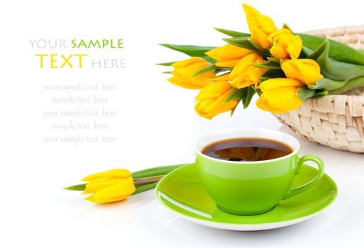 coffee cup with yellow tulips, on white background.