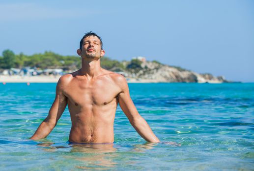 Young man having fun in oceans water