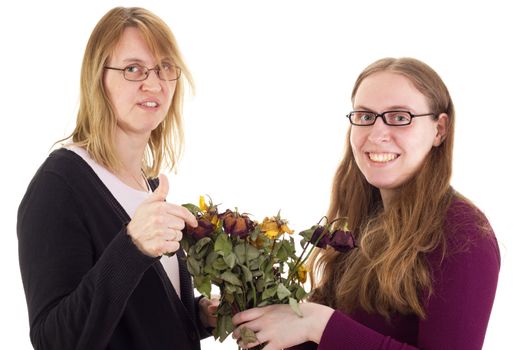 Daughter giving mother dried roses