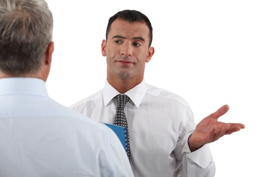 Businessman explaining point to colleague