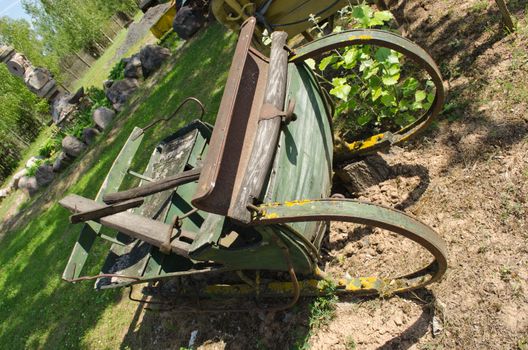 closeup of retro rusty vintage carriage rest in park.