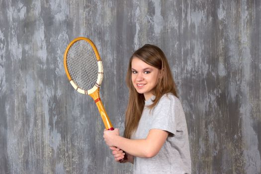 Action portrait of a girl with tennis racket