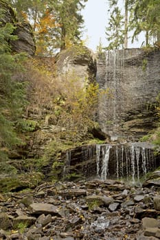 A cascading waterfall in the autumn forest