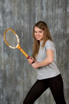 Action portrait of a girl with tennis racket