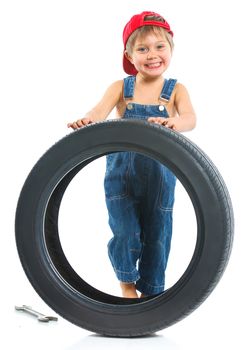Cute little mechanic with a tire and wrench