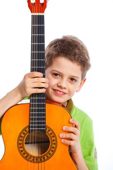 Portait of cute boy with classical guitar. Isolated on white background