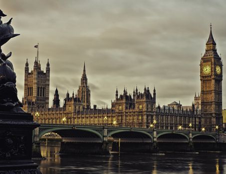 Atmospheric view of the historical Houses of Parliament, London, England and Big Ben taken across the waters of the Thames on an overcast day