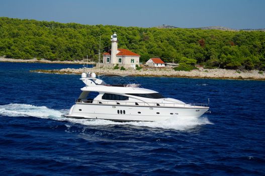 Luxuri yacht cruising near the lighthouse in Croatia