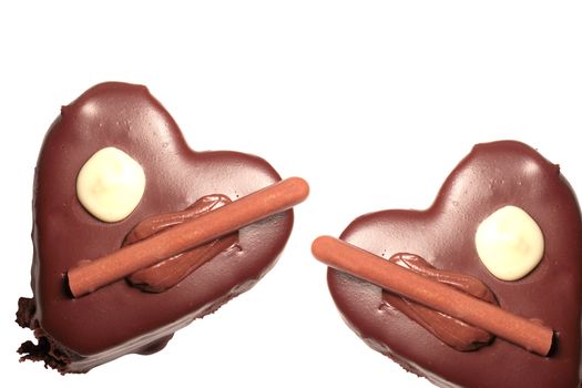 Chocolate cakes in the shape of a heart on white background
