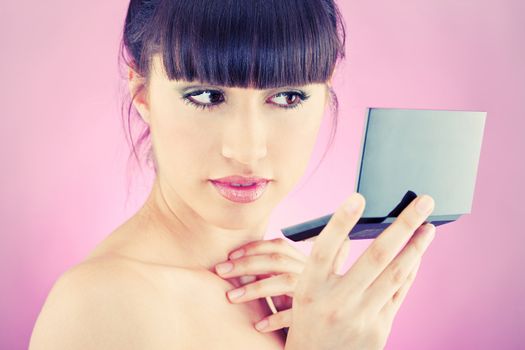 Pretty woman checking face skin, looking at mirror