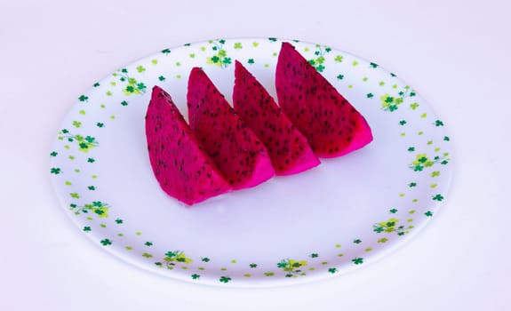 Red dragon fruit cut into pieces in white dish
